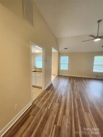 a view of a room with wooden floor and a window