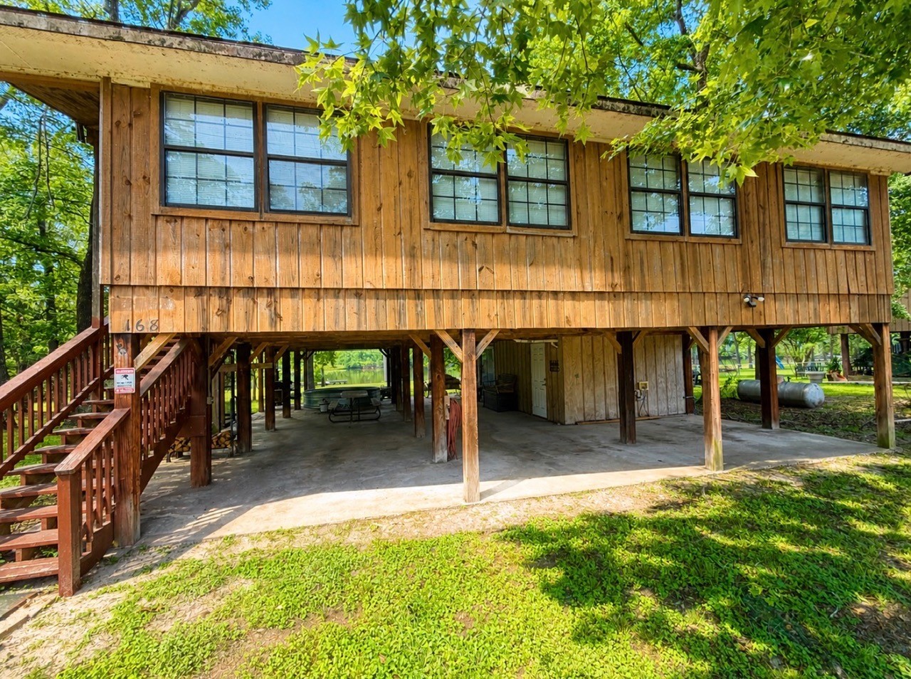 168 Timberline Drive Trinity, TX 75862 - Photo 16 of 20 a backyard of a house with table and chairs