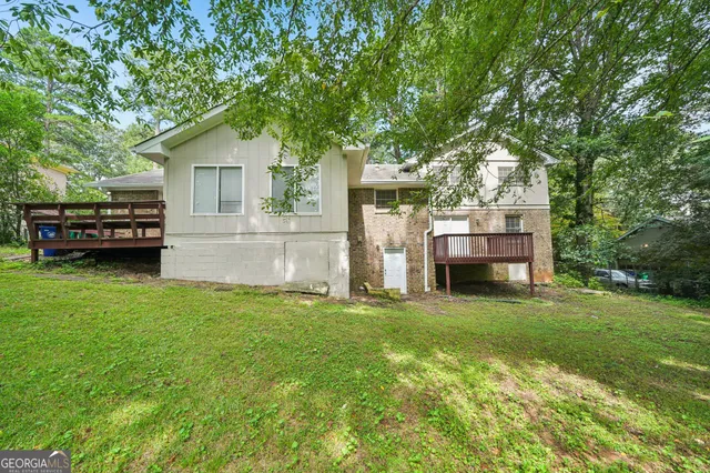 a view of a house with a yard and sitting area
