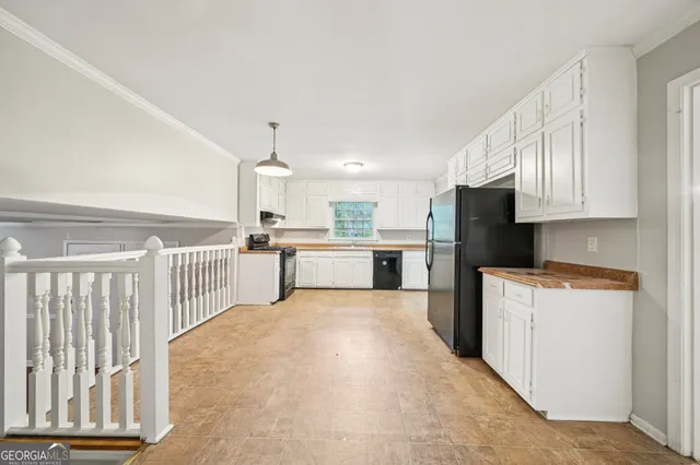 a kitchen with cabinets and a refrigerator