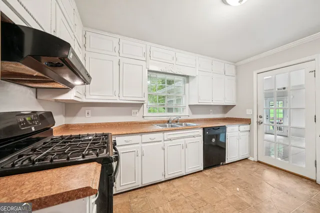 a kitchen with a stove a sink and a refrigerator
