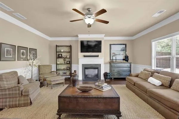 a living room with furniture a fireplace and a flat screen tv