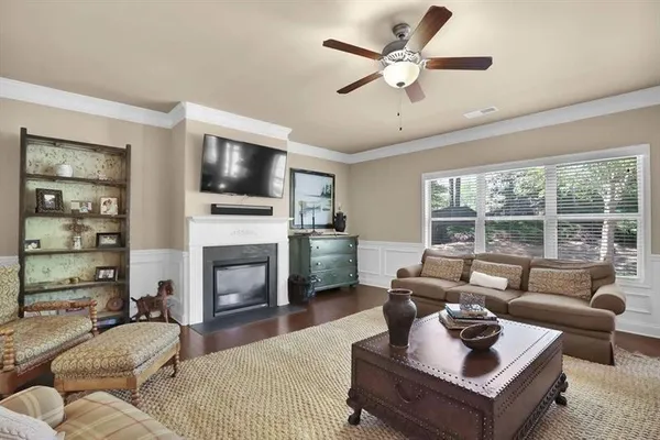a living room with furniture a fireplace and a flat screen tv