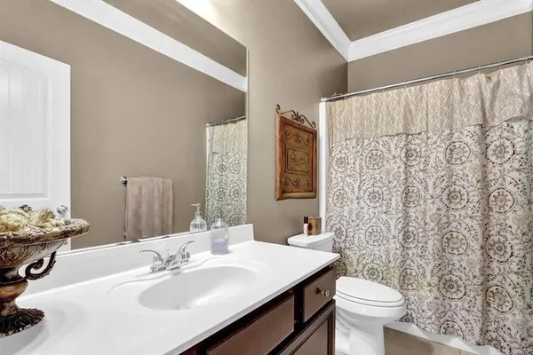 a bathroom with a sink toilet and mirror