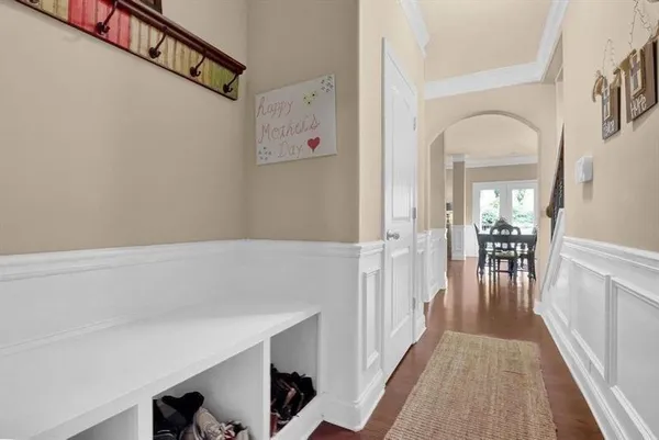 a view of a hallway with entryway wooden floor and front door