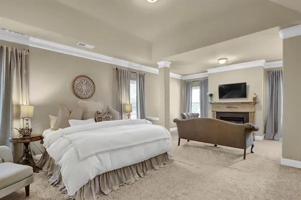 a bedroom with a bed and a television