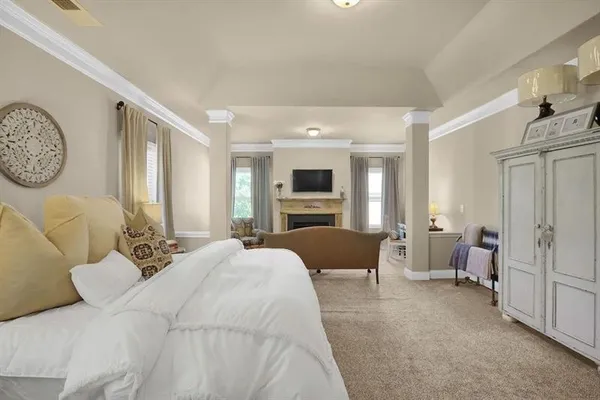 a bedroom with furniture and a fireplace