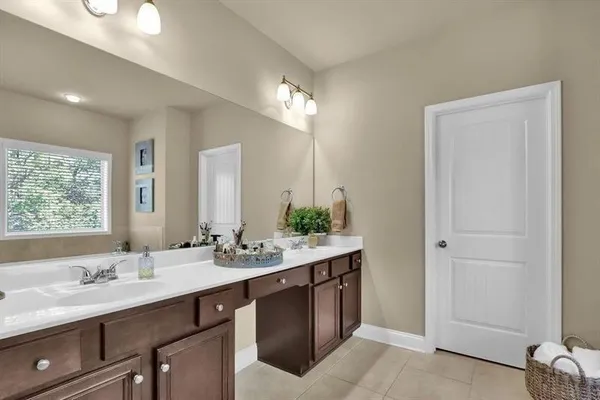 a bathroom with a double vanity sink and a mirror