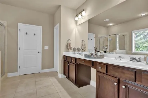 a bathroom with a sink double vanity and a mirror