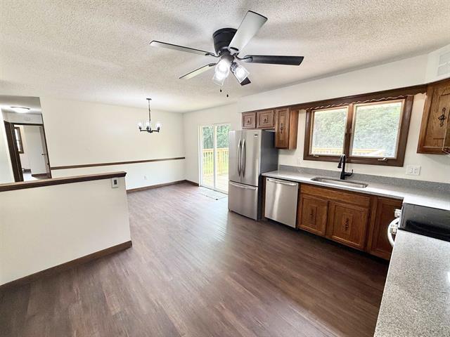 8567 Valley View Drive Stillman Valley, IL 61084 - Photo 12 of 29 a open kitchen with stainless steel appliances granite countertop a sink cabinets and wooden floor