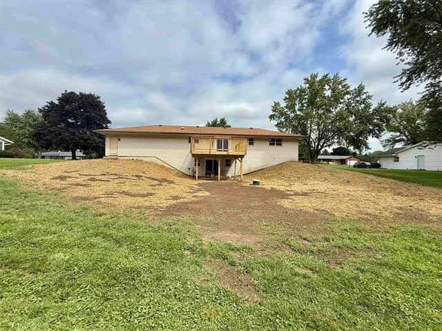 a view of a house with a yard and garage