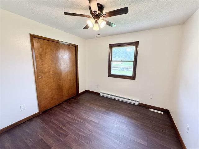 8567 Valley View Drive Stillman Valley, IL 61084 - Photo 21 of 29 an empty room with wooden floor chandelier fan and windows
