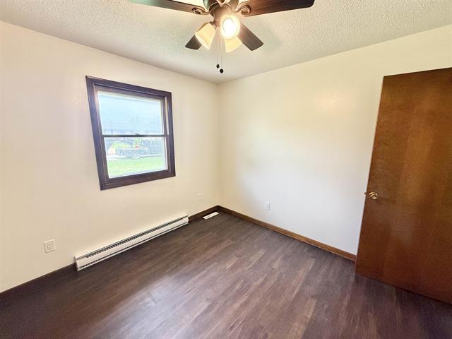 8567 Valley View Drive Stillman Valley, IL 61084 - Photo 22 of 29 an empty room with wooden floor chandelier fan and windows