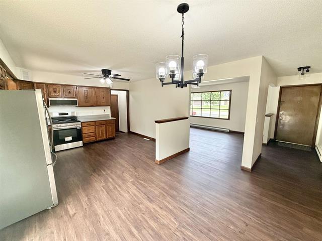 8567 Valley View Drive Stillman Valley, IL 61084 - Photo 10 of 29 a living room with hard wood floors furniture and kitchen view