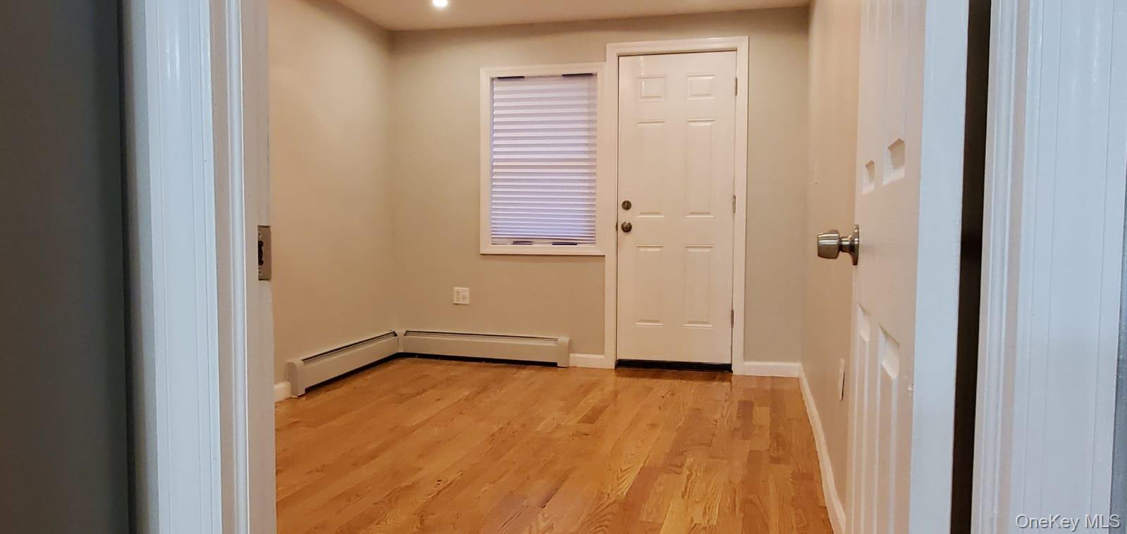 914 Duncan Street Bronx, NY 10469 - Photo 7 of 10 a view of an empty room with wooden floor