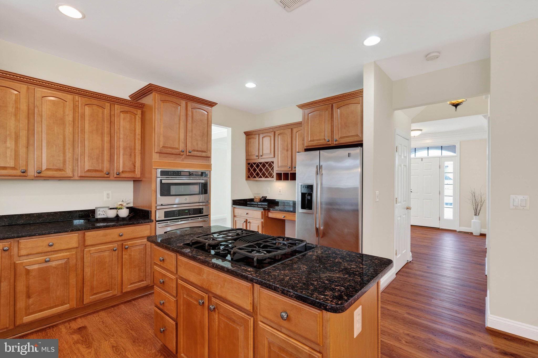 3313 Lady Catherine Circle Triangle, VA 22172 - Photo 11 of 51 a kitchen with wooden cabinets and stainless steel appliances