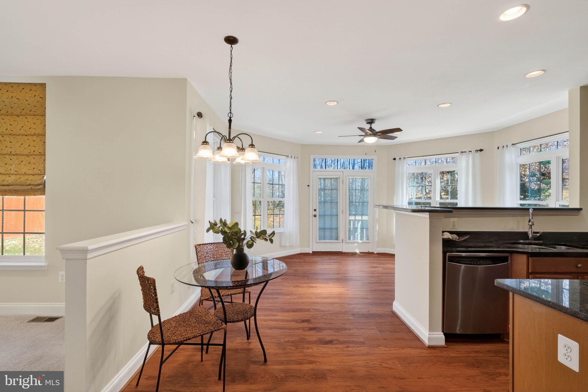 3313 Lady Catherine Circle Triangle, VA 22172 - Photo 12 of 51 a dining room with furniture a chandelier and wooden floor