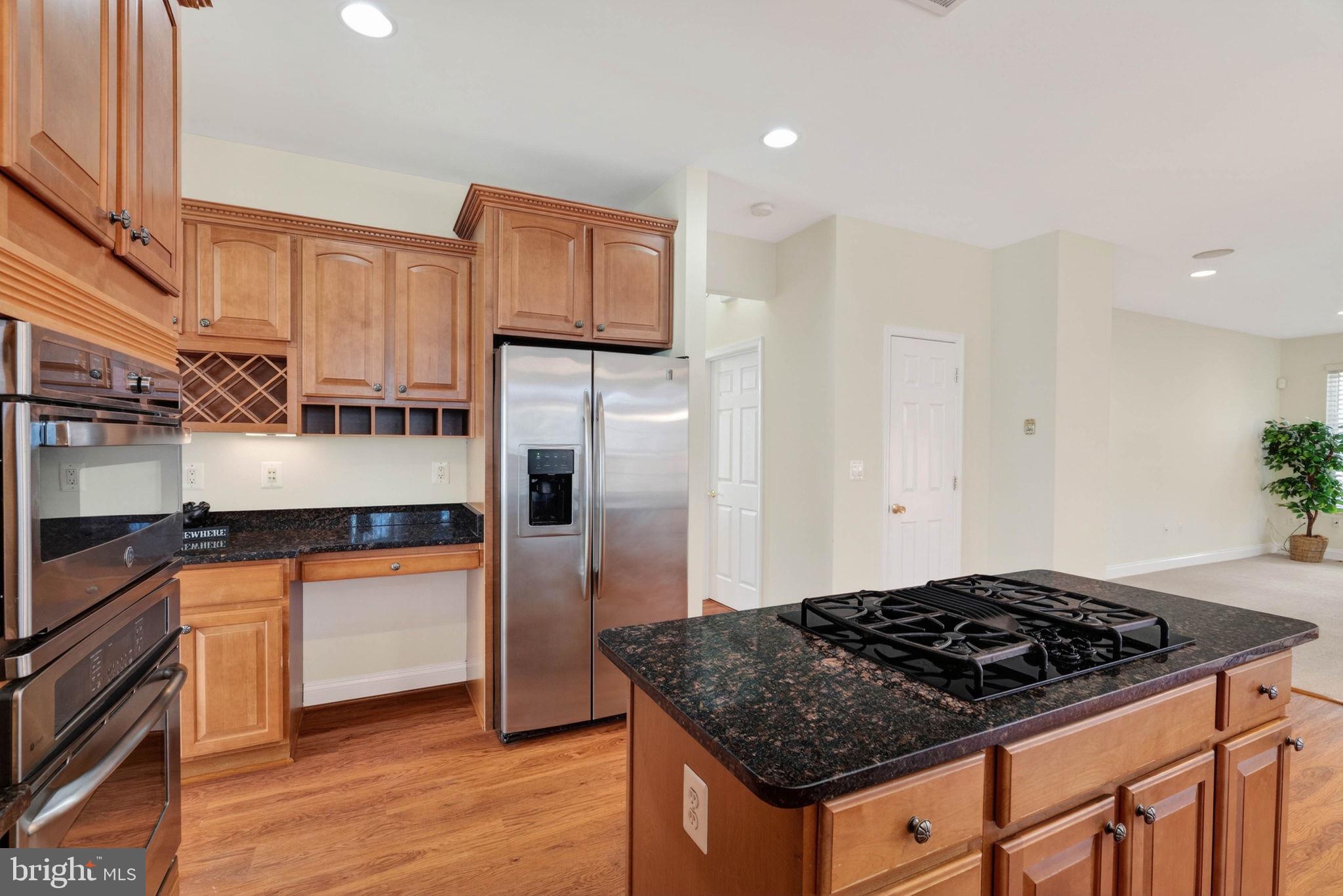 3313 Lady Catherine Circle Triangle, VA 22172 - Photo 14 of 51 a kitchen with granite countertop a sink stove and refrigerator