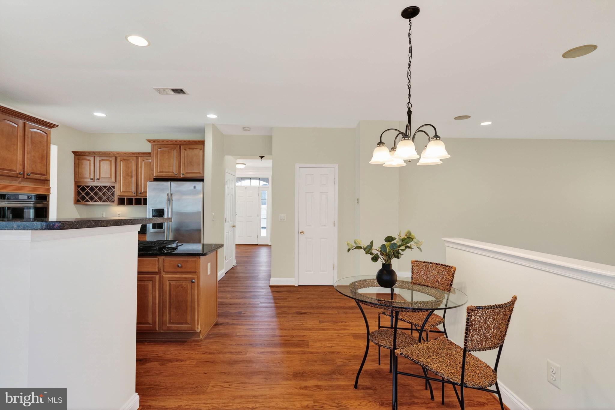 3313 Lady Catherine Circle Triangle, VA 22172 - Photo 15 of 51 a view of a dining room with furniture wooden floor and a chandelier