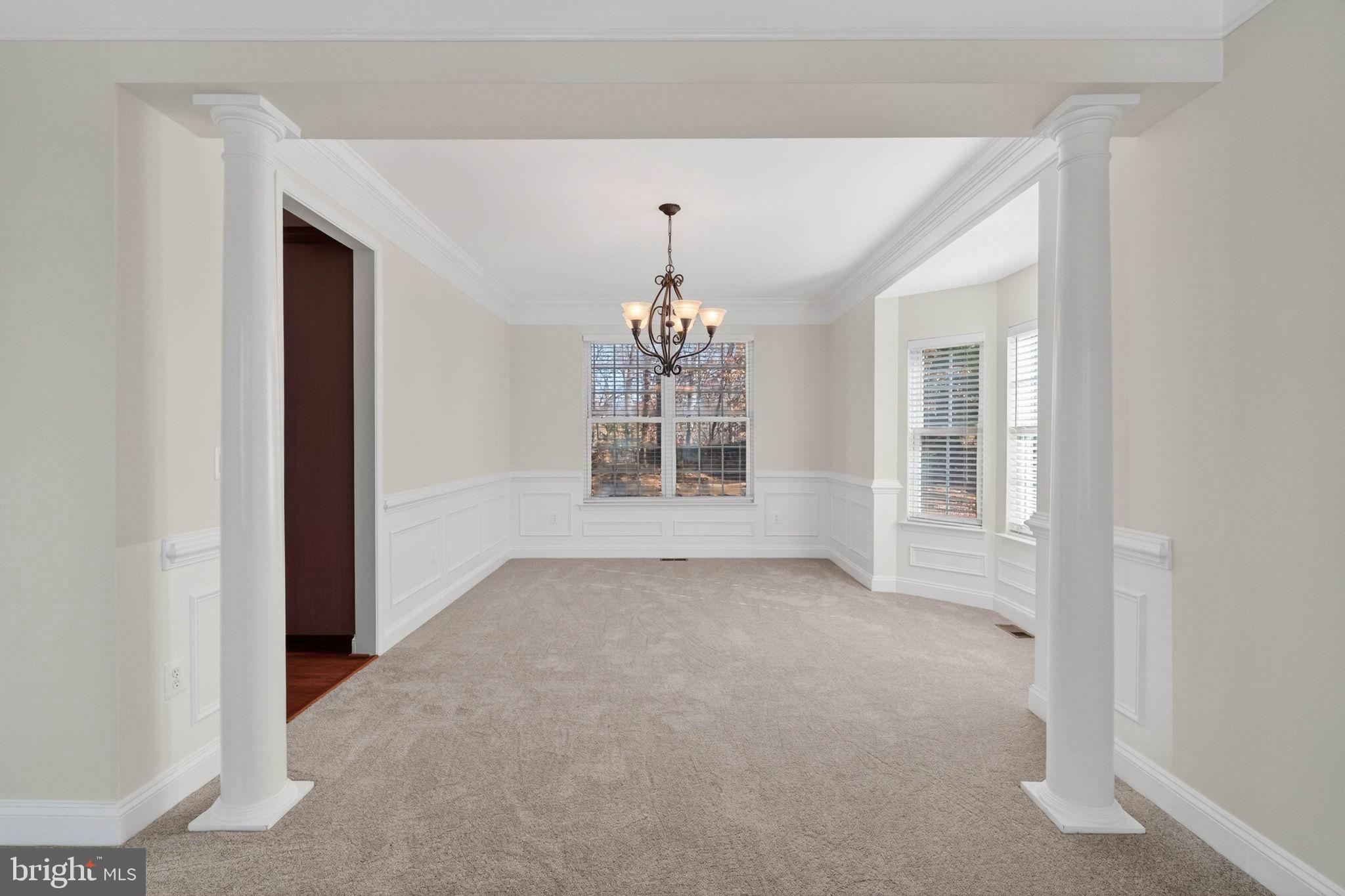 3313 Lady Catherine Circle Triangle, VA 22172 - Photo 20 of 51 an empty room with windows and chandelier