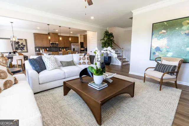 a living room with furniture and view of kitchen