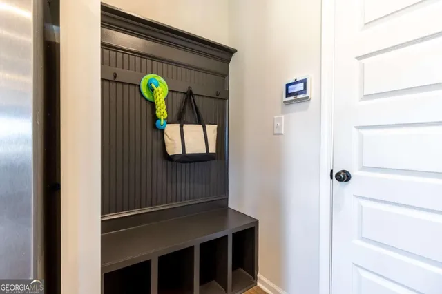 a living room with furniture a rug and a wall painting
