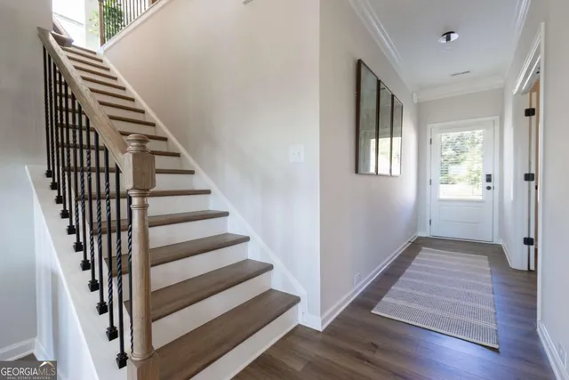 a view of a hallway with wooden floor and entryway