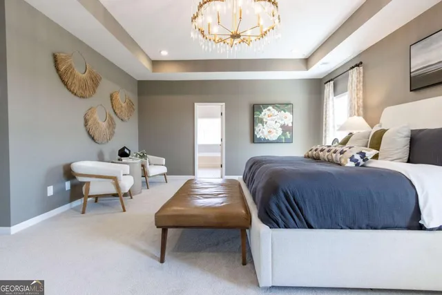 a spacious bedroom with a bed a chandelier and a dresser