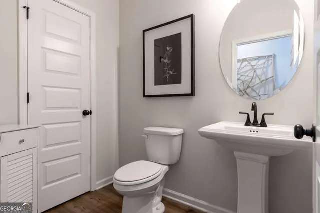 a bathroom with a toilet sink and vanity