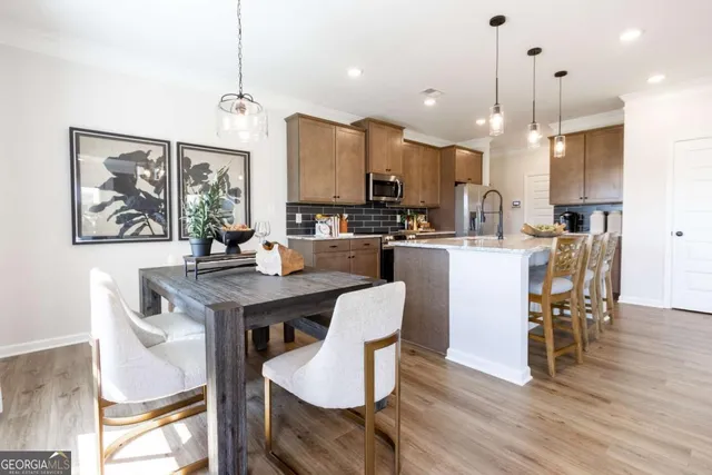 a view of a dining room with furniture window and wooden floor