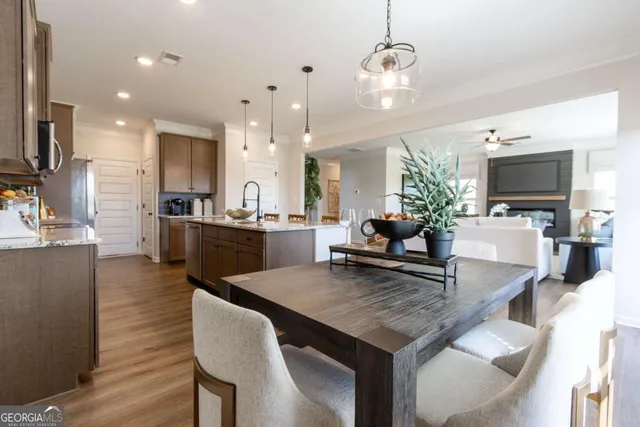 a view of kitchen and living room with wooden floor