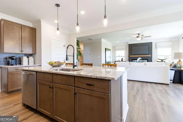 a kitchen with sink and view living room