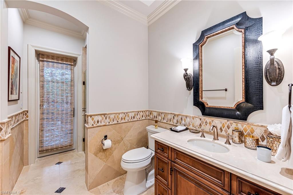 2560 Half Moon Walk Naples, FL 34102 - Photo 33 of 44 Bathroom with vanity, toilet, ornamental molding, and tile walls