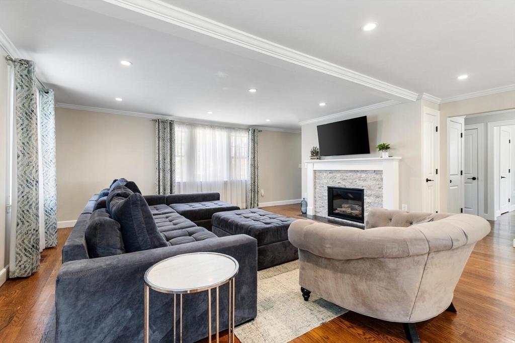 149 Robbins Road Watertown, MA 02472 - Photo 7 of 33 a living room with furniture a fireplace and a flat screen tv