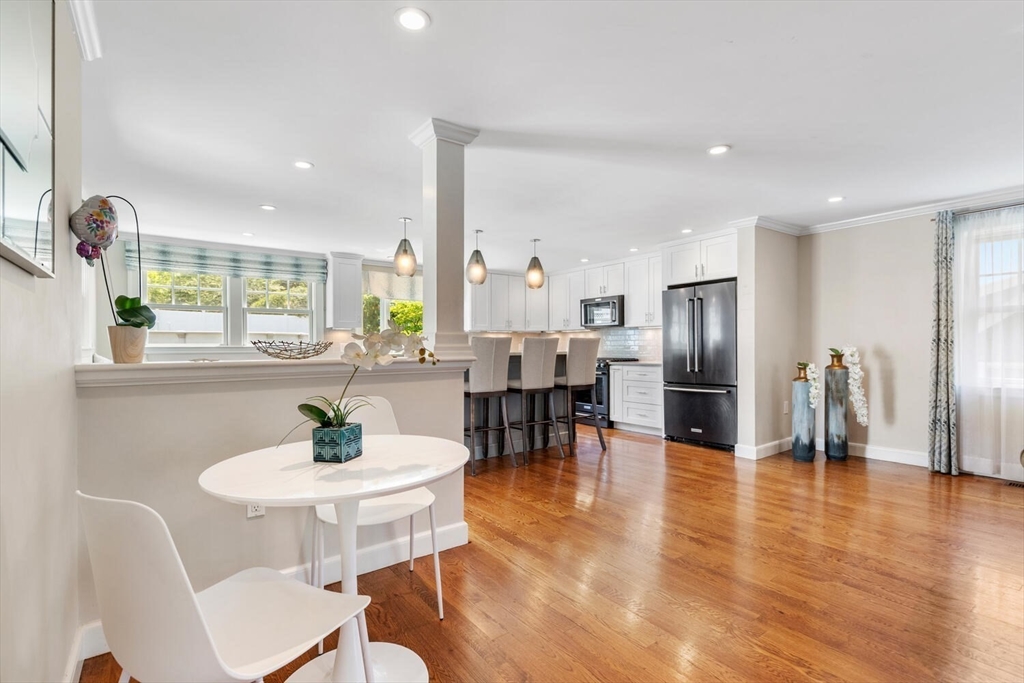 149 Robbins Road Watertown, MA 02472 - Photo 10 of 33 a kitchen with stainless steel appliances a dining table chairs and a refrigerator