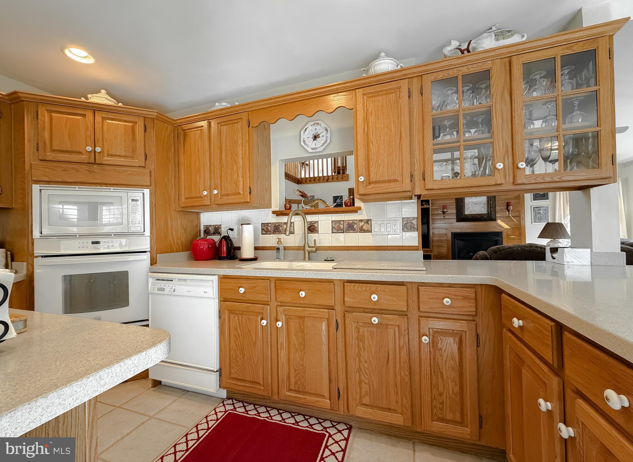 48712 Packer Court St. Inigoes, MD 20684 - Photo 16 of 55 a kitchen with stainless steel appliances granite countertop a stove a sink dishwasher and cabinets with wooden floor