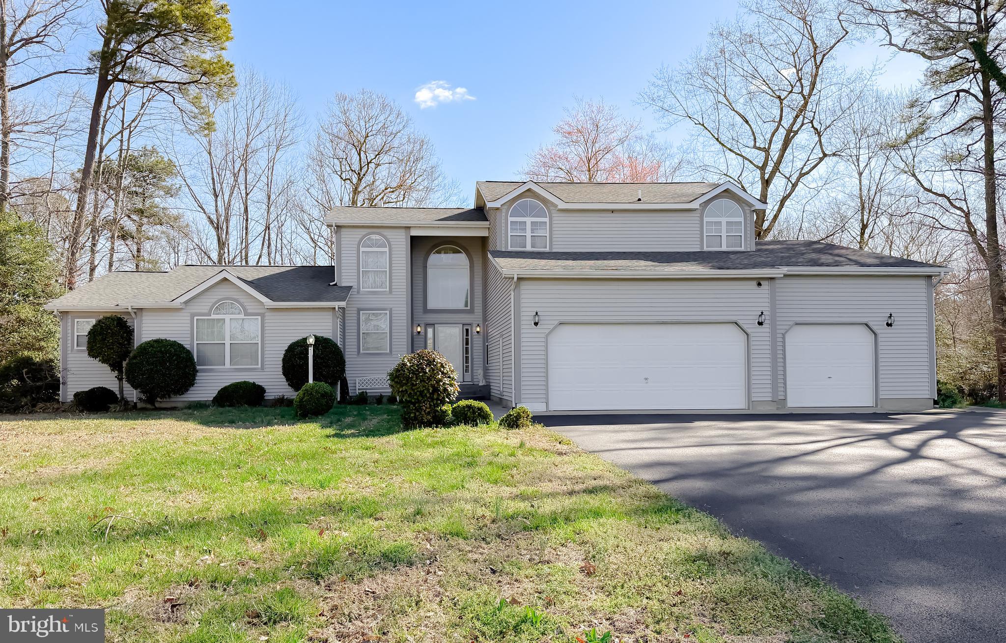 48712 Packer Court St. Inigoes, MD 20684 - Photo 2 of 55 a view of a house with a yard and large trees