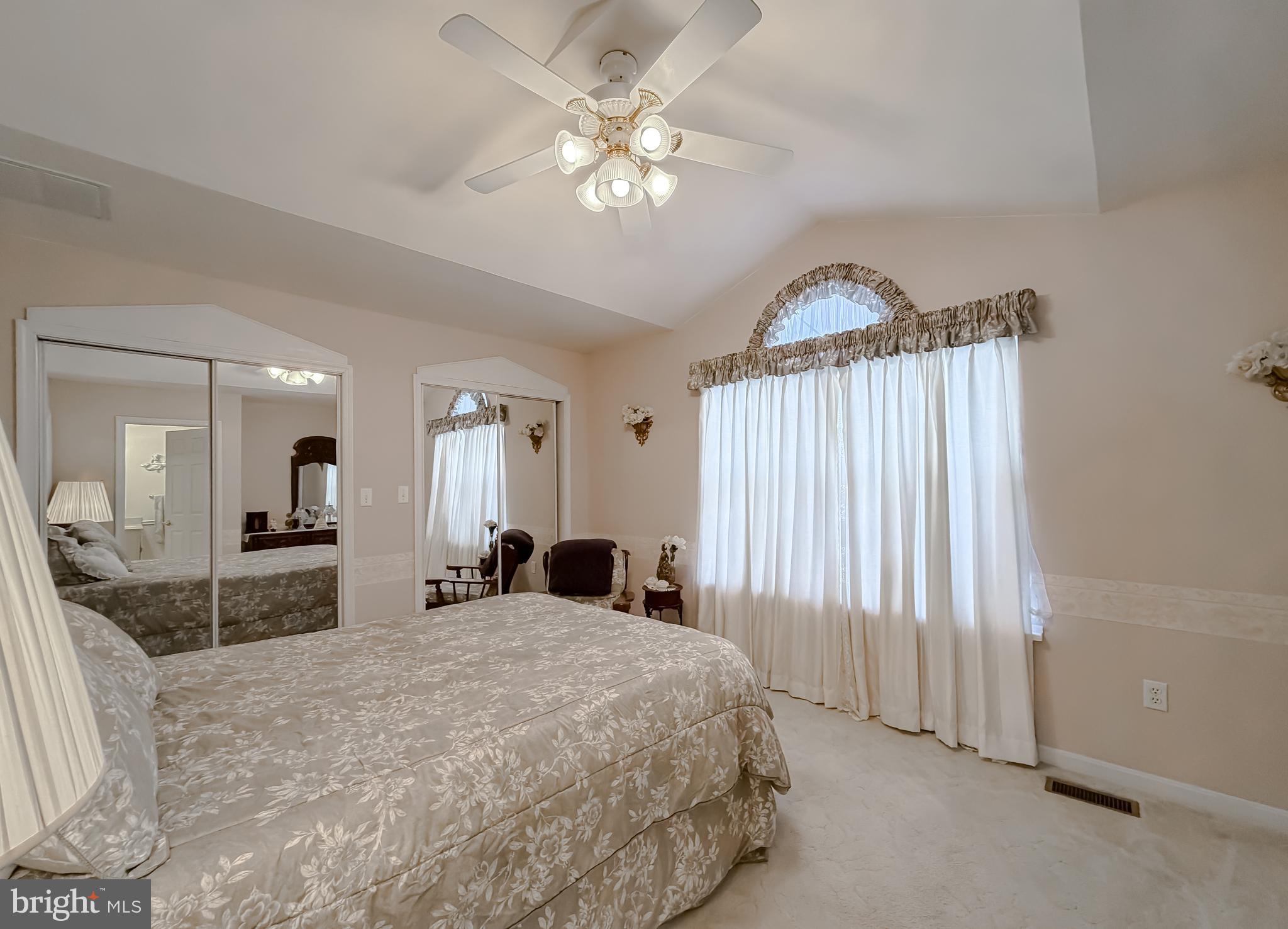 48712 Packer Court St. Inigoes, MD 20684 - Photo 31 of 55 a spacious bedroom with a large bed and a chandelier