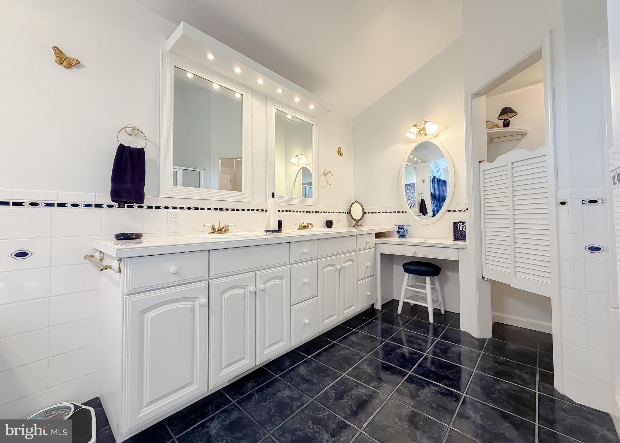 48712 Packer Court St. Inigoes, MD 20684 - Photo 40 of 55 a spacious bathroom with a double vanity sink a mirror and a