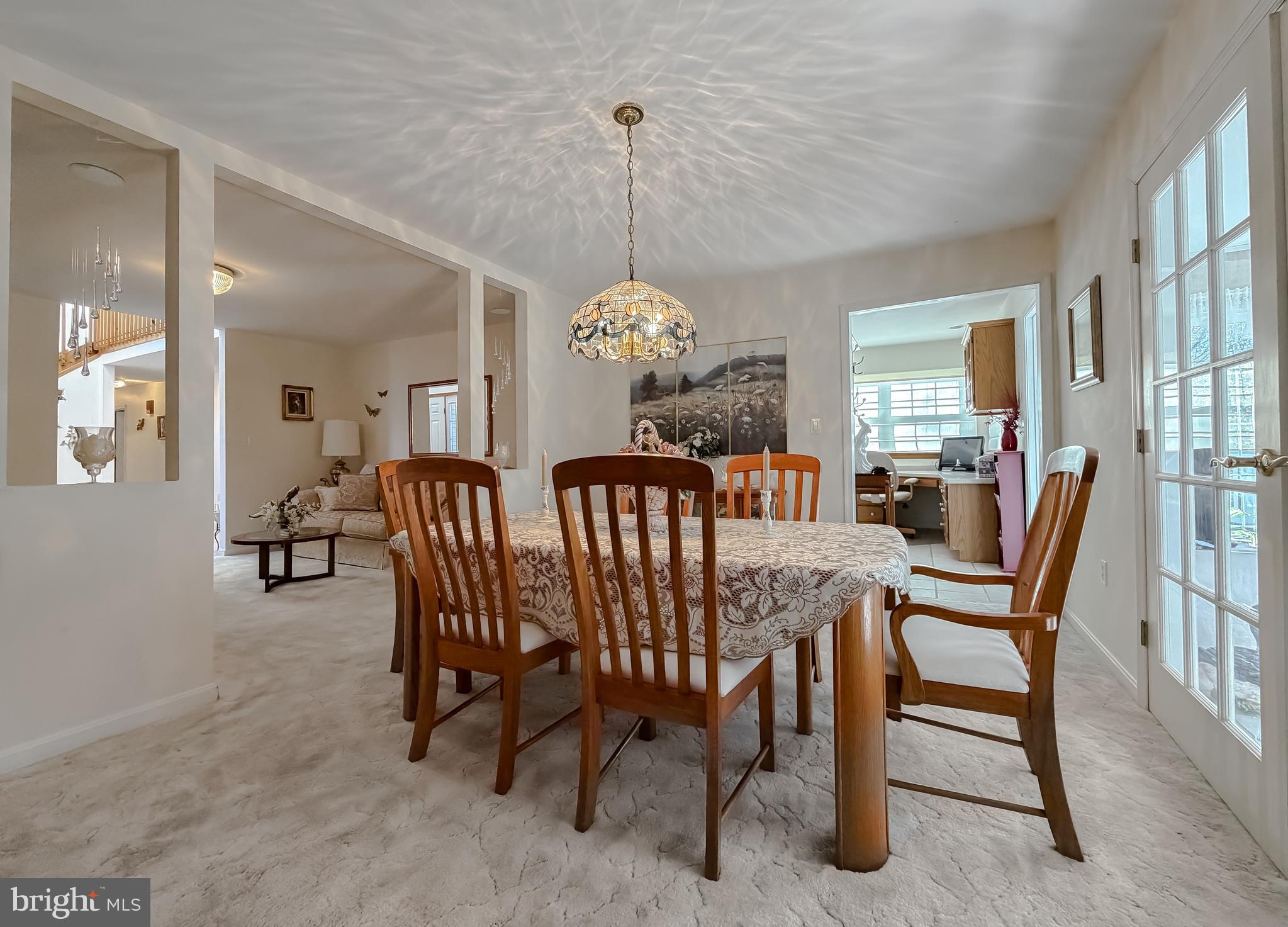 48712 Packer Court St. Inigoes, MD 20684 - Photo 7 of 55 a dining room with furniture a chandelier and a rug