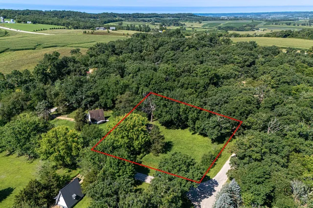 an aerial view of a houses with a yard