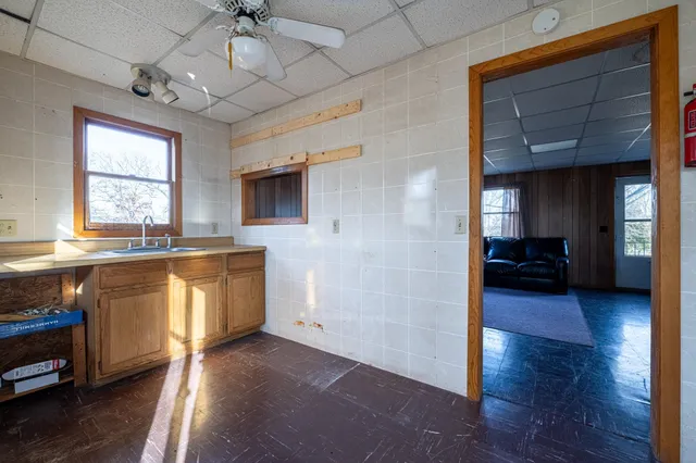 a view of living room with granite countertop furniture and a ceiling fan