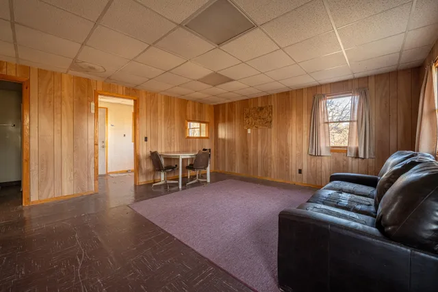 a living room with furniture and large windows
