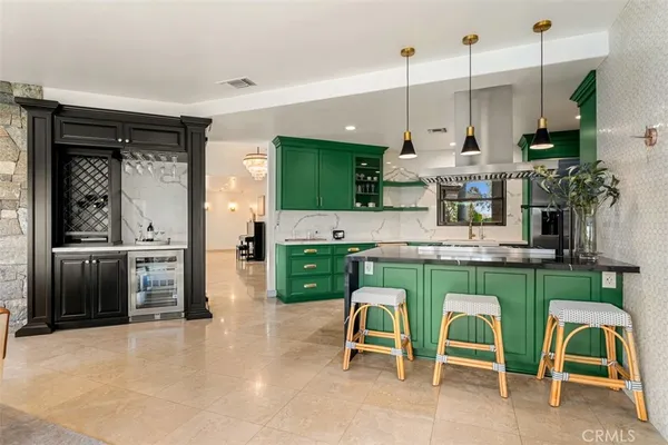 a kitchen with stainless steel appliances granite countertop a stove and a refrigerator