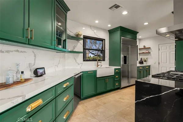 a kitchen with stainless steel appliances granite countertop a stove and a sink