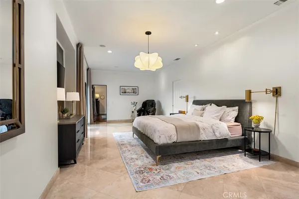 a living room with furniture a large window and wooden floor