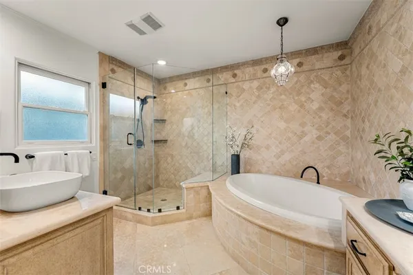 a bathroom with a granite countertop shower a sink and a mirror