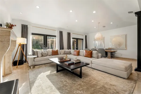 a living room with furniture a rug and a fireplace