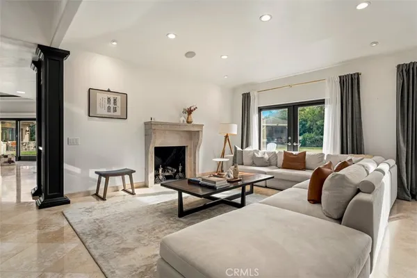 a living room with furniture a window and a chandelier
