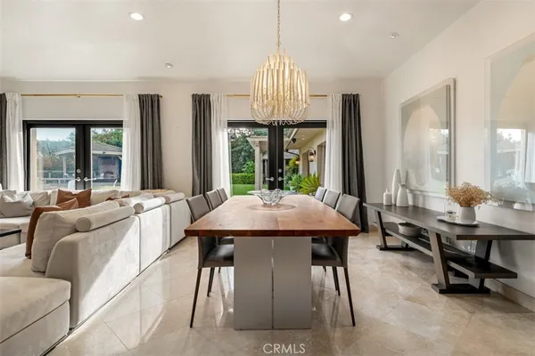 a kitchen with stainless steel appliances kitchen island granite countertop a table and chairs in it